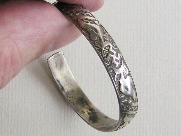 Silver bangle decorated with swastikas – (0671)
